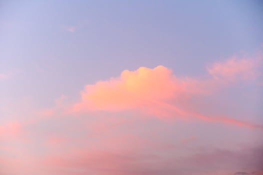 Light pink clouds in sunset blue sky. photo