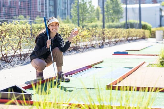 Mini-golf ball on artificial grass. Summer season game photo
