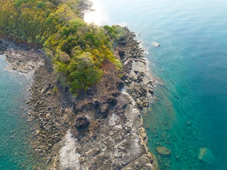 Aerial drone view of beautiful rocky with turquoise sea water and trees of Gulf of Thailand. Kood island, Thailand photo