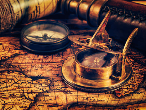 Old vintage compass on ancient map photo