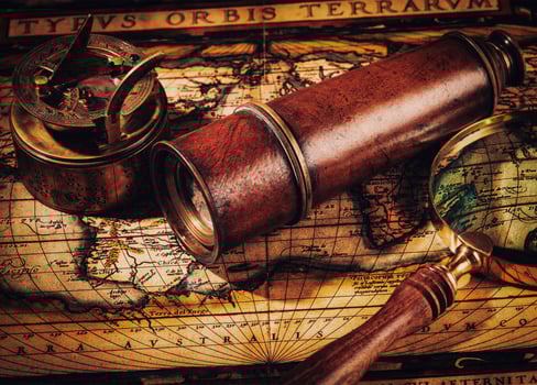Old vintage compass on ancient map photo