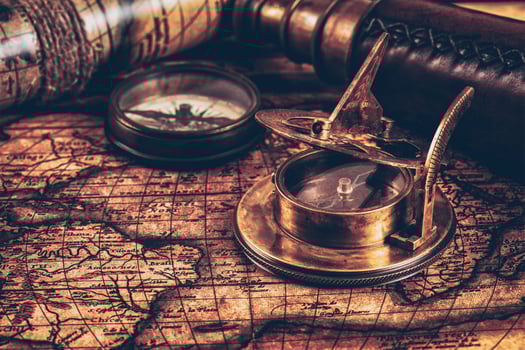Old vintage compass on ancient map photo