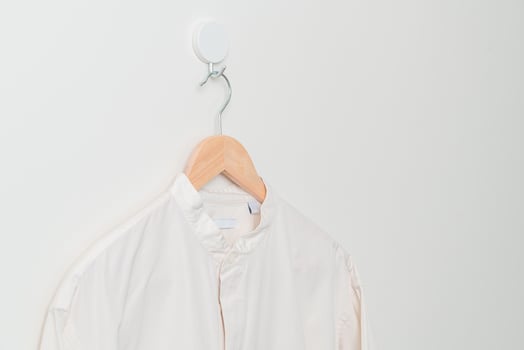 hanging shirt with wood hanger on wall photo