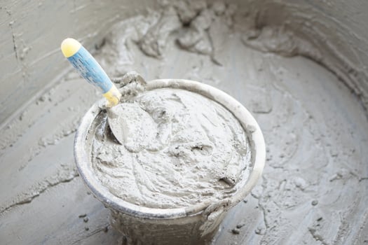 Bucket of well mixed cement and sand for construction with a trowel. Concept. Construction job. Process of construction work with cement. Choose good quality and proper material product for building photo