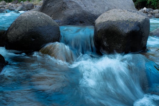waterfall with turquoise water and rock cliffs photo
