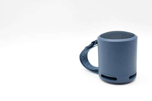 Portable wireless blue speaker isolated on white background. photo