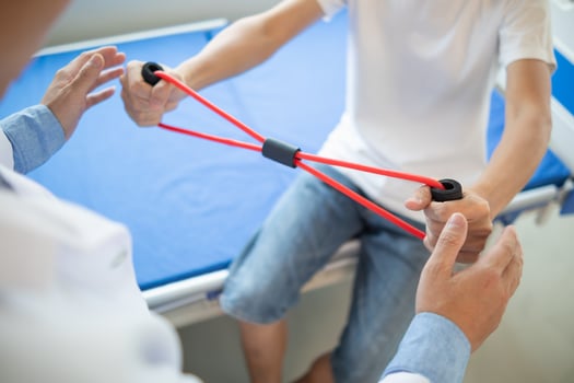 doctor is examining muscle injury and using elastic bands test injury and also help with physical therapy strengthen muscles because physical therapy will help strengthen muscles and help blood flow. photo