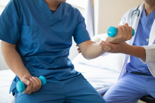 doctor is checking for muscle injuries and using dumbbells test injury and also help with physical therapy strengthen muscles because physical therapy will help strengthen muscles and help blood flow photo