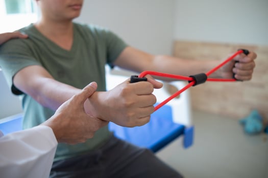 doctor is examining muscle injury and using elastic bands test injury and also help with physical therapy strengthen muscles because physical therapy will help strengthen muscles and help blood flow. photo