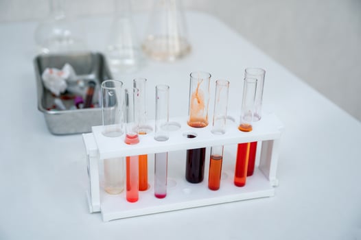 Various colors chemical test tubes in rack at lab photo