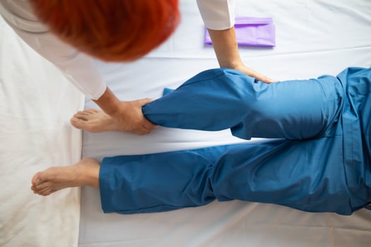 Doctors are examining patient muscle injuries and doing physical therapy for patient to move muscles so they can be used regularly because physical therapy will help strengthen muscles and blood flow. photo