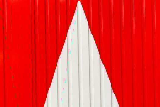 Metal wall, white arrow on red background photo