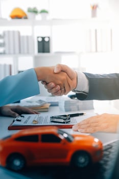 Insurance officers hand over the car keys after the tenant. have signed an auto insurance document or a lease or agreement document Buying or selling a new or used car with a car photo