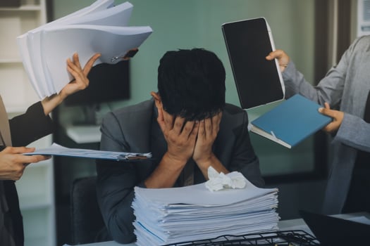 Stressful business man have so many paperwork in the office photo