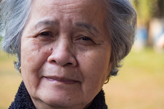 Close-up of face senior woman smiling and looking at the camera. Concept of aged people and healthcare photo