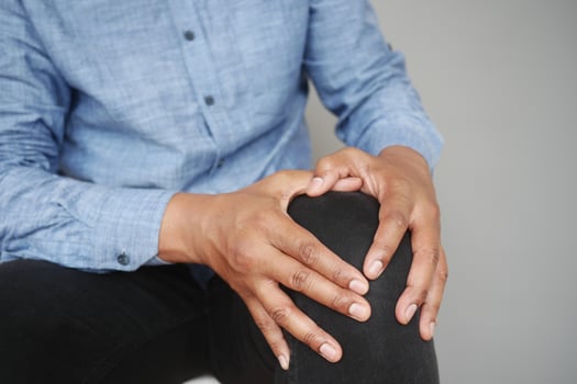 Close up on man suffering knee joint pain photo
