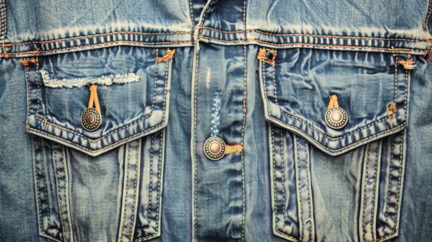 Detailed Texture of Vintage Denim Jacket with Metallic Buttons photo