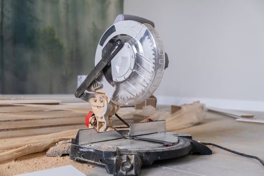 The miter saw or a multi material construction saw on the floor of the apartment photo
