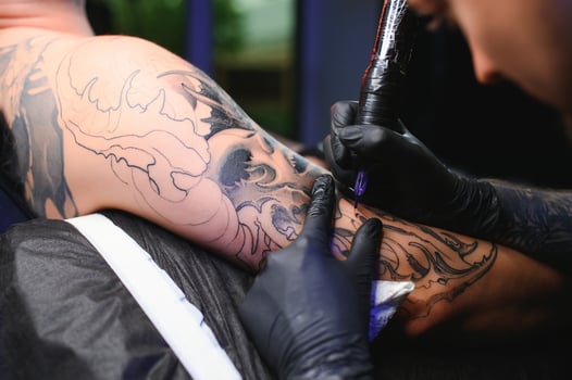 Professional tattoo artist makes a tattoo photo