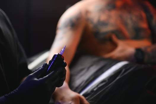 Professional tattoo artist makes a tattoo photo