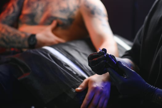 Professional tattoo artist makes a tattoo photo