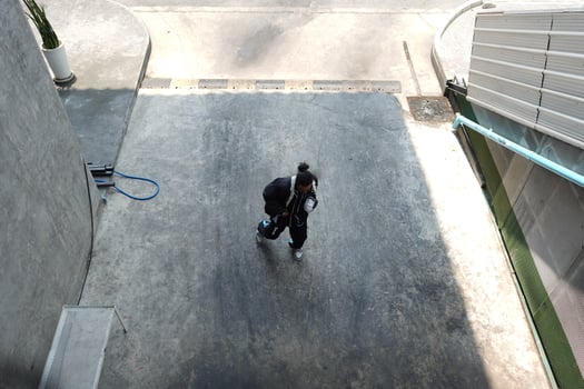 ASian man is dancing in hip hop style at outdoor space. Professional solo dancer is performing in public area. photo