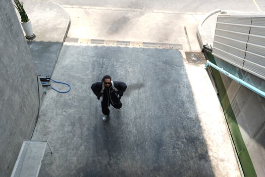 ASian man is dancing in hip hop style at outdoor space. Professional solo dancer is performing in public area. photo