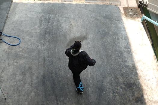 ASian man is dancing in hip hop style at outdoor space. Professional solo dancer is performing in public area. photo