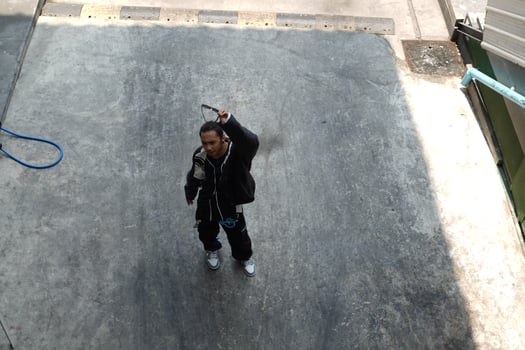 ASian man is dancing in hip hop style at outdoor space. Professional solo dancer is performing in public area. photo