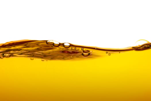 orange juice is isolated on white background. healthy fresh drink and natural waves. close up view. photo