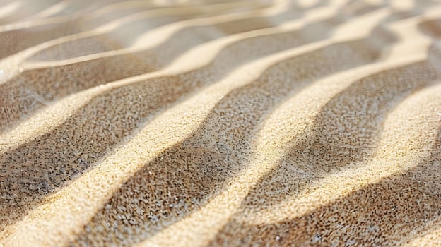 Close up of sandy dune with gentle waves photo
