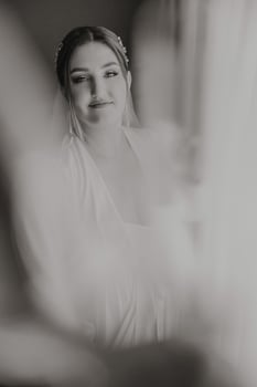 A woman is wearing a white dress and a veil photo