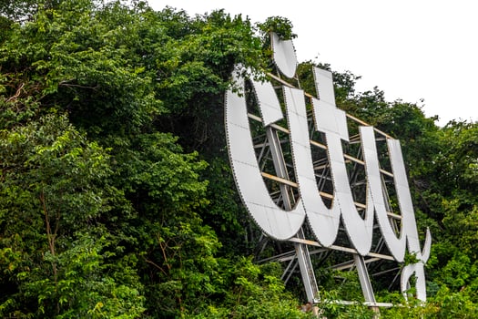 Pattaya City name sign lettering letters on hill in Thailand. photo
