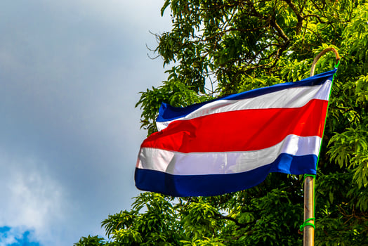 Costa Rican flag with blue sky background Alajuela Costa Rica. photo