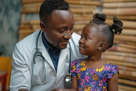 African American young girl is being examined by a doctor photo
