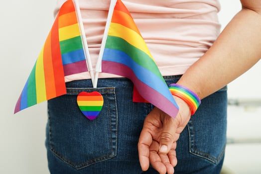 Asian woman with rainbow flag, LGBT symbol rights and gender equality, LGBT Pride Month in June. photo