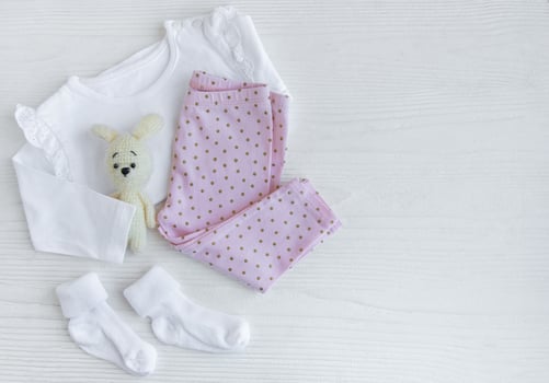 Set of baby bodysuits, pants, socks and knitted toy photo