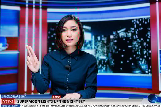 Correspondent addresses supermoon incident on talk show, delivering live commentary on sky illuminating massive moon. Asian tv host on global television channel reading headlines. photo