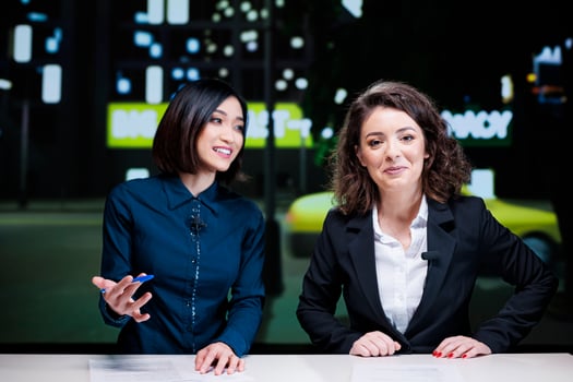 Night show hosts talk about events, reporting latest topics with exclusive information. Diverse journalists team presenting celebrity drama or daily news to create television content. photo