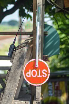 a stop sign that hangs on a railroad crossing photo