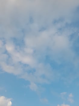 Beautiful white clouds on deep blue sky background. Large bright soft fluffy clouds are cover the entire blue sky. photo