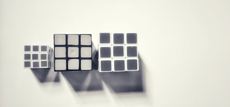 MAGELANG, INDONESIA. April 25th, 2024 - Black and white photo of three Rubik's photographed by giving a shadow effect to the object.