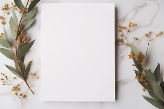Wedding invitation or card mockup. Blank white sheet of copy space on a natural stone surface, decorative twigs with leaves. photo