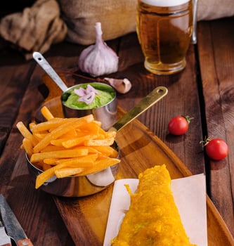 Classic fish and french fries meal with beer photo