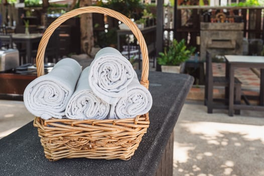 Folded roll towels stacked in wooden basket photo