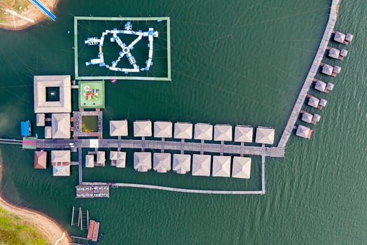 Wooden raft resort with water park floating on dam photo