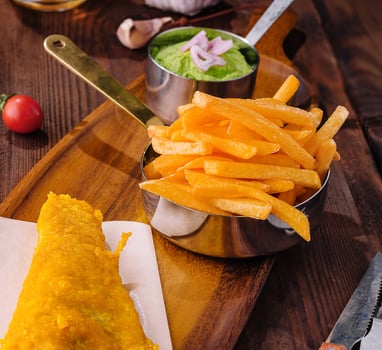 Classic fish and chips meal on wooden board photo