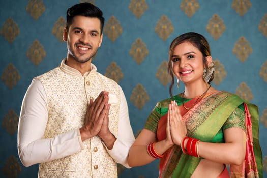 Modern Couple In Traditional Attire Greeting Namaste In Front Of The Camera photo