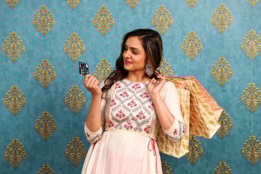 A Lovely Indian Dress Woman Holding Debit Card And Shopping Bags In Hand photo