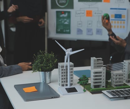 Business people having consultation about wind energy at company office. Business team discussing about windmill and alternative green energy. Executive meeting at modern office photo
